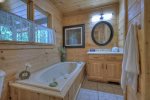 Upstairs master bathroom with a jetted tub and shower stall